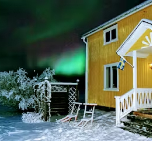 A yellow house with snow outside