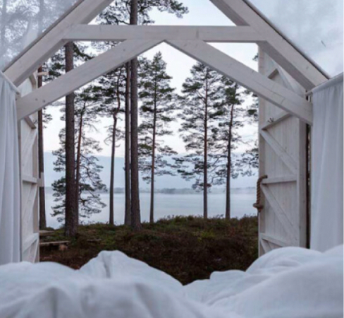 A glashouse with a lake outside